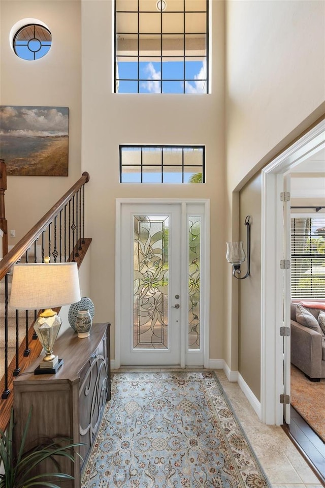 1254 Cielo Ct, North Venice, FL 34275 - foyer entrance with stairway, baseboards, and a towering ceiling