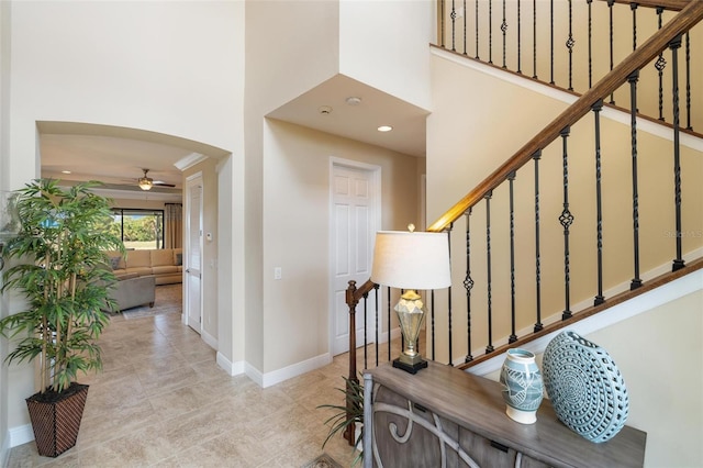 1254 Cielo Ct, North Venice, FL 34275 - entryway with arched walkways, baseboards, a ceiling fan, a high ceiling, and stairway