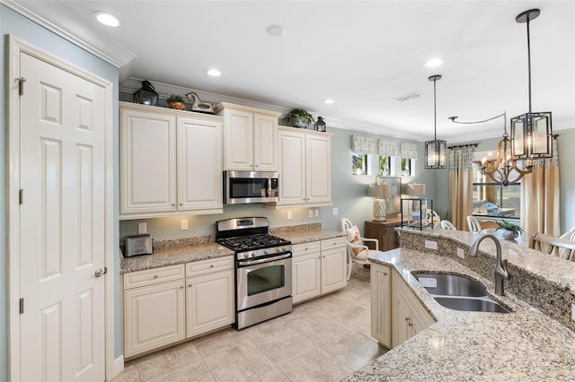 1254 Cielo Ct, North Venice, FL 34275 - kitchen featuring an inviting chandelier, a sink, crown molding, hanging light fixtures, and appliances with stainless steel finishes