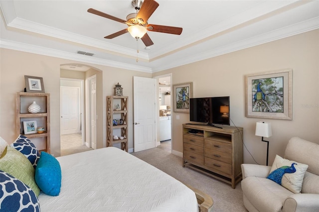 1254 Cielo Ct, North Venice, FL 34275 - bedroom with a tray ceiling, visible vents, light carpet, ornamental molding, and arched walkways