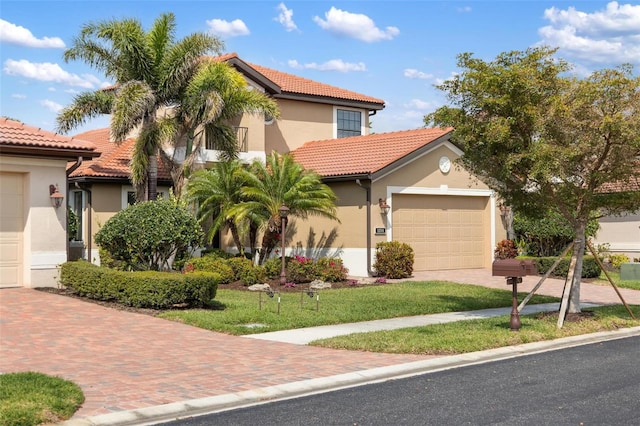 1254 Cielo Ct, North Venice, FL 34275 - mediterranean / spanish-style house with stucco siding, a tile roof, and a garage