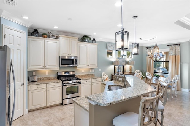1254 Cielo Ct, North Venice, FL 34275 - kitchen with stainless steel appliances, a sink, visible vents, crown molding, and a breakfast bar