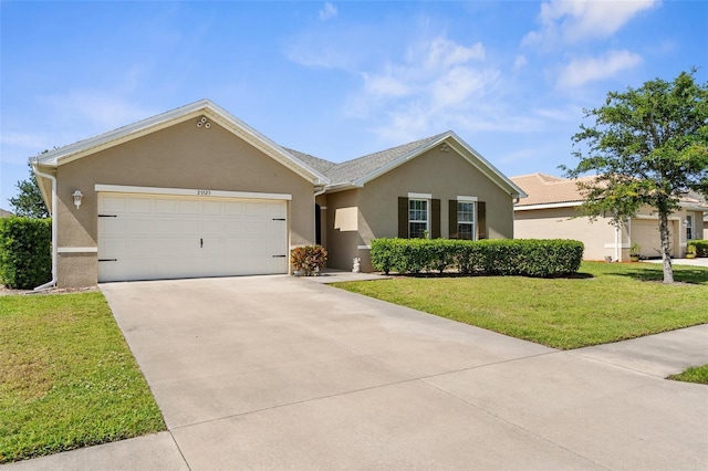 25525 Lambert Ln, Punta Gorda, FL 33950 - ranch-style home with a garage, stucco siding, driveway, and a front yard