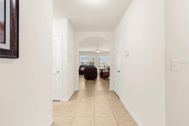 25525 Lambert Ln, Punta Gorda, FL 33950 - hall featuring light tile patterned floors, baseboards, and arched walkways