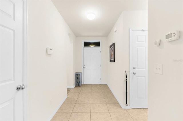 25525 Lambert Ln, Punta Gorda, FL 33950 - corridor featuring light tile patterned flooring and baseboards
