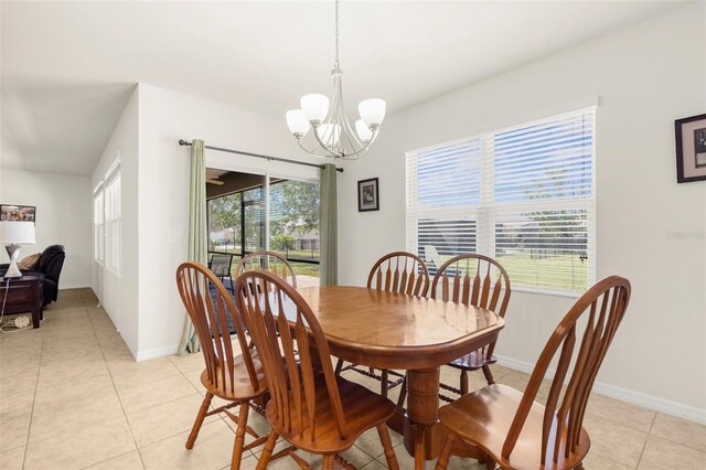 25525 Lambert Ln, Punta Gorda, FL 33950 - dining room featuring light tile patterned flooring, an inviting chandelier, baseboards, and plenty of natural light