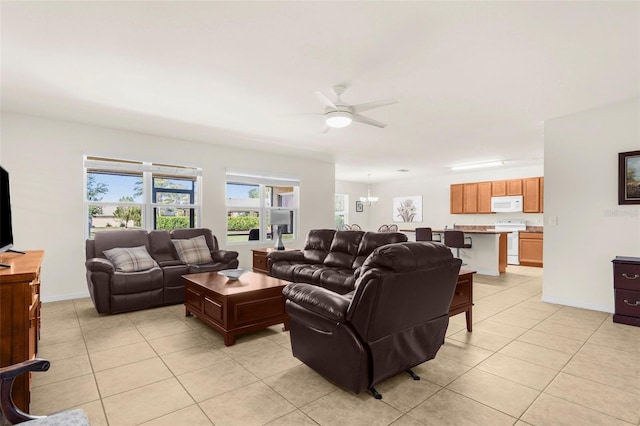 25525 Lambert Ln, Punta Gorda, FL 33950 - living room featuring baseboards, a ceiling fan, and light tile patterned flooring