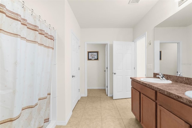 25525 Lambert Ln, Punta Gorda, FL 33950 - bathroom with baseboards, double vanity, tile patterned flooring, visible vents, and a sink