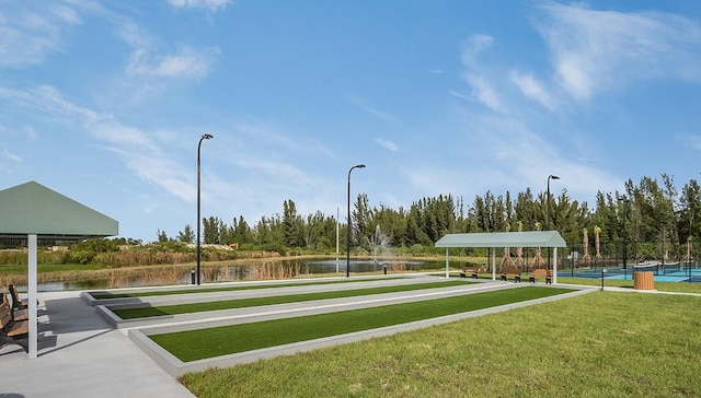 25525 Lambert Ln, Punta Gorda, FL 33950 - view of home's community featuring a water view, a tennis court, fence, and a lawn