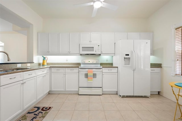 1007 Gondola Park Dr Unit 1007, Venice, FL 34292 - kitchen with white appliances, white cabinetry, a ceiling fan, dark stone countertops, and light tile patterned floors