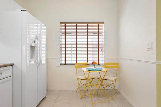 1007 Gondola Park Dr Unit 1007, Venice, FL 34292 - kitchen with white fridge with ice dispenser, white cabinets, and light tile patterned floors