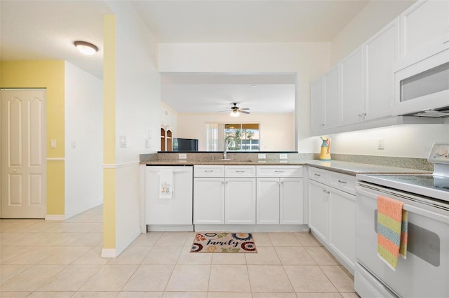 1007 Gondola Park Dr Unit 1007, Venice, FL 34292 - kitchen featuring white appliances, light tile patterned floors, a ceiling fan, and white cabinetry