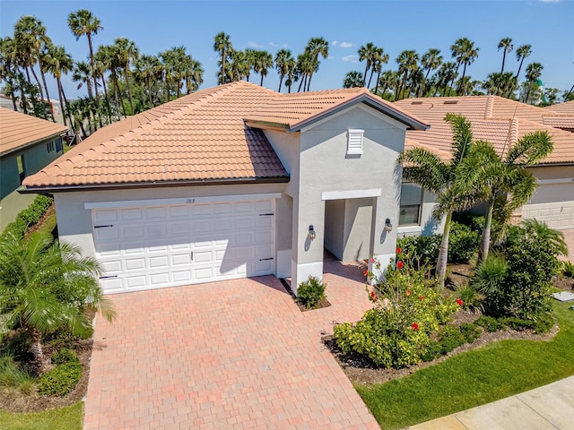 288 Soliera St, Nokomis, FL 34275 - mediterranean / spanish-style home featuring stucco siding, a tile roof, a garage, and decorative driveway