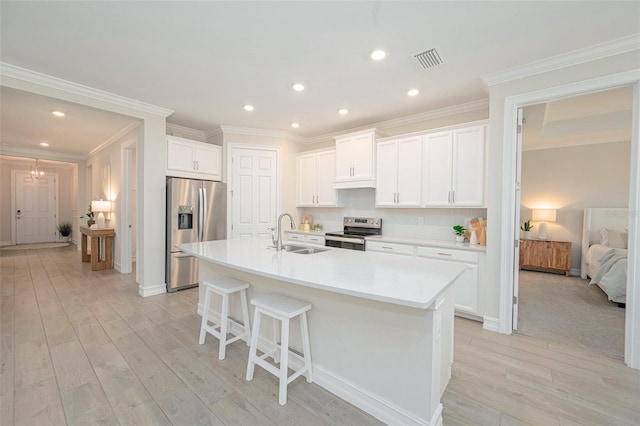 288 Soliera St, Nokomis, FL 34275 - kitchen with light wood-type flooring, stainless steel appliances, a center island with sink, a sink, and visible vents