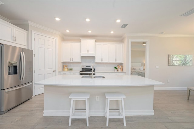 288 Soliera St, Nokomis, FL 34275 - kitchen featuring visible vents, stainless steel appliances, a center island with sink, a sink, and light wood-style floors