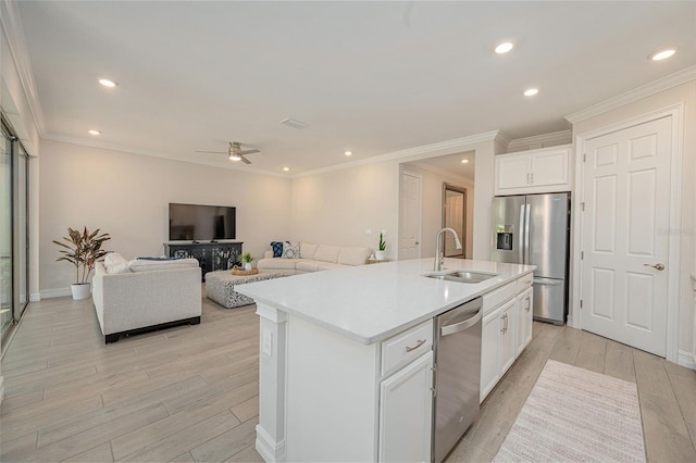288 Soliera St, Nokomis, FL 34275 - kitchen featuring white cabinetry, stainless steel appliances, a sink, an island with sink, and light wood-style flooring