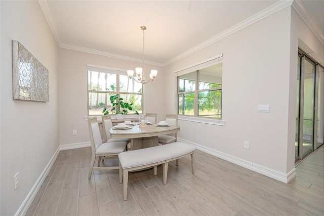 288 Soliera St, Nokomis, FL 34275 - dining area with baseboards, a chandelier, light wood-style floors, and crown molding