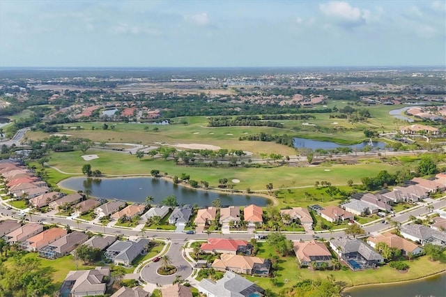 birds eye view of property with golf course view, a water view, and a residential view