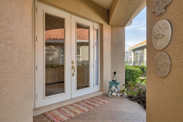 doorway to property with stucco siding and french doors