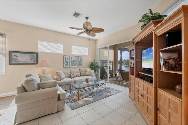 living area featuring light tile patterned flooring, baseboards, ceiling fan, and visible vents