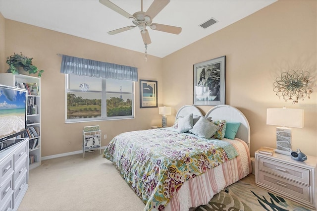 bedroom featuring light colored carpet, visible vents, ceiling fan, and baseboards