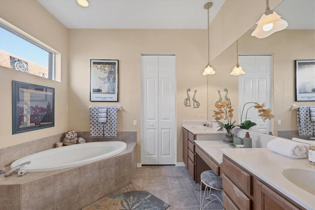 full bath with tile patterned floors, vanity, a closet, and a bath