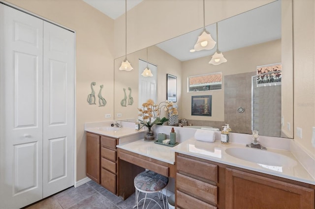 full bath with tile patterned floors, a sink, double vanity, a closet, and a walk in shower
