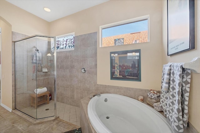 bathroom with tile patterned flooring, a garden tub, and a tile shower