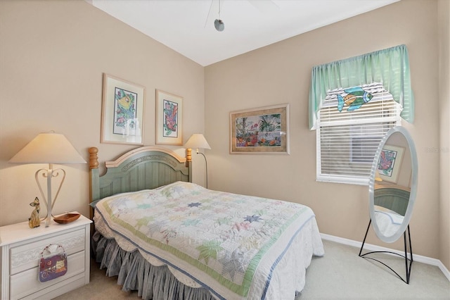bedroom featuring baseboards, a ceiling fan, and light colored carpet