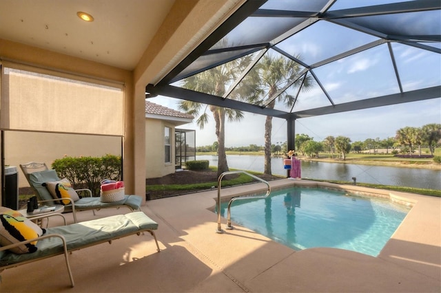 pool featuring glass enclosure, a water view, and a patio