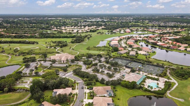 aerial view with golf course view, a water view, and a residential view