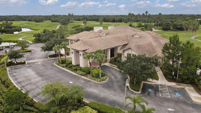 bird's eye view with a water view and view of golf course
