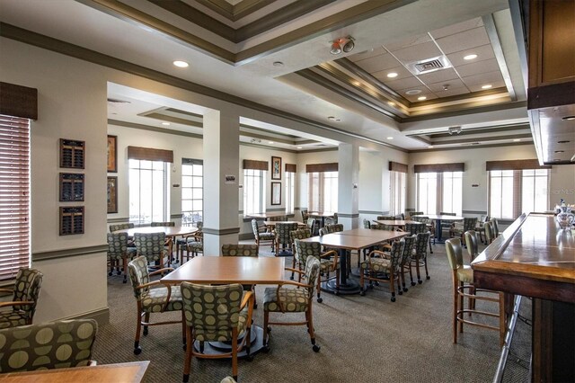 dining space featuring visible vents, carpet, ornamental molding, recessed lighting, and a raised ceiling