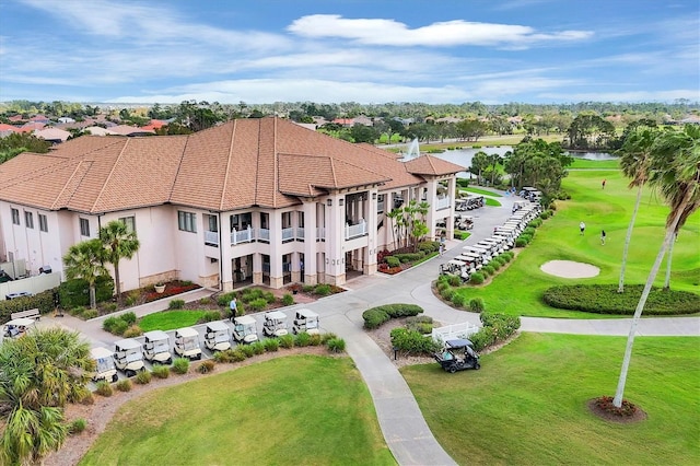 aerial view featuring golf course view and a water view