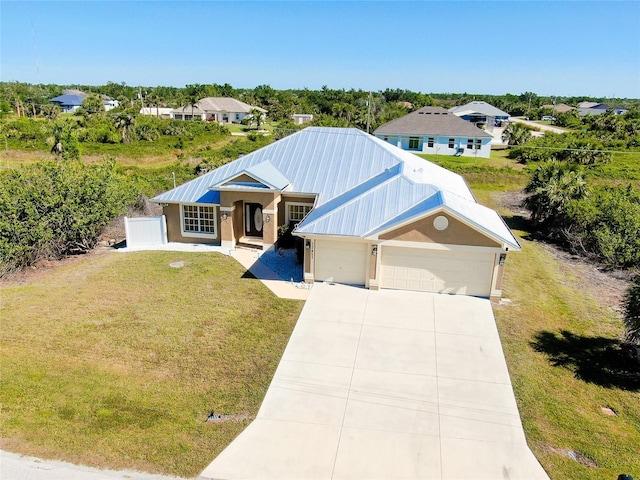 13452 High Springs Ave, Port Charlotte, FL 33981 - view of front facade featuring an attached garage, a front lawn, a metal roof, driveway, and stucco siding