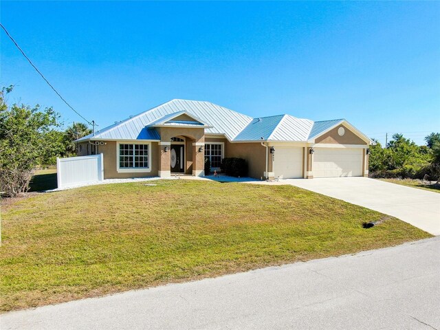 13452 High Springs Ave, Port Charlotte, FL 33981 - ranch-style house with an attached garage, driveway, a metal roof, and stucco siding