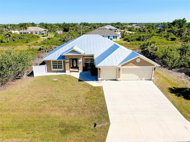 13452 High Springs Ave, Port Charlotte, FL 33981 - ranch-style house with a garage, a front yard, concrete driveway, and a metal roof