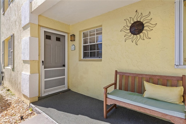 entrance to property with stucco siding