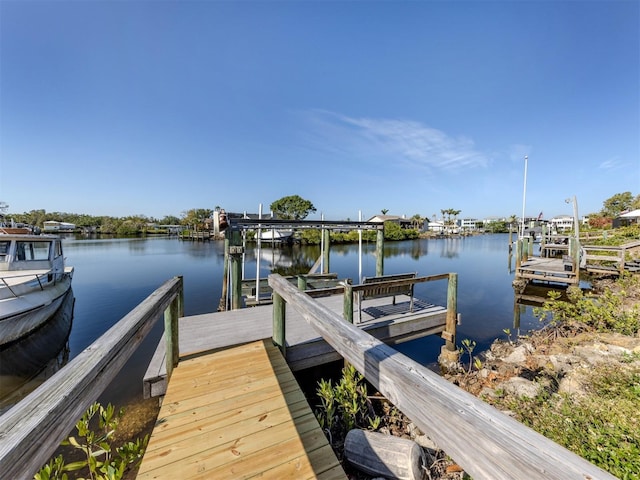 view of dock featuring a water view and boat lift