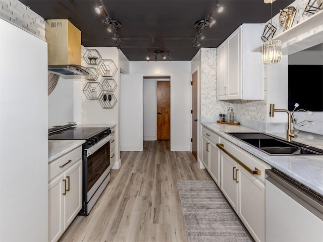 kitchen featuring island exhaust hood, white fridge, electric range, a sink, and dishwashing machine
