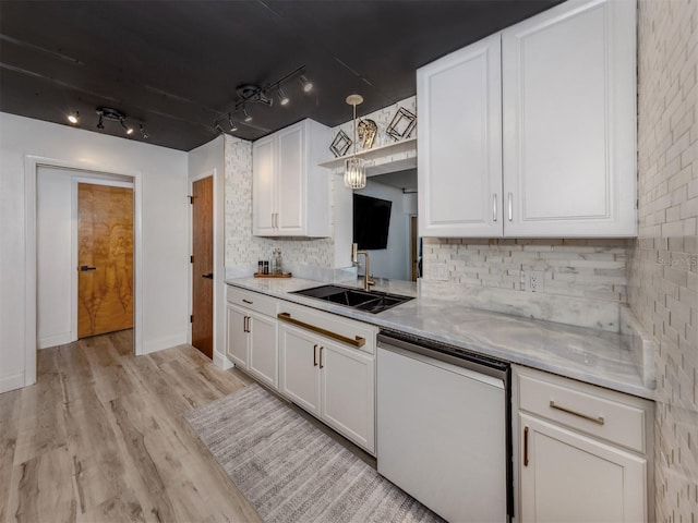 kitchen with white cabinetry, white dishwasher, a sink, and light countertops