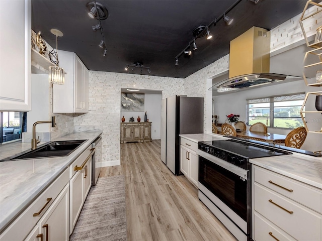 kitchen with a sink, white cabinetry, stainless steel appliances, island exhaust hood, and light wood-style floors