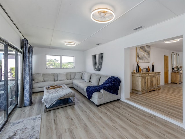 living room with visible vents and light wood-style floors