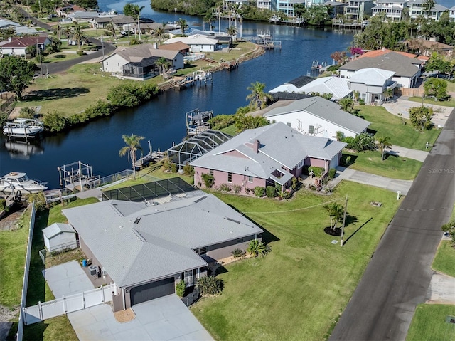 drone / aerial view featuring a residential view and a water view