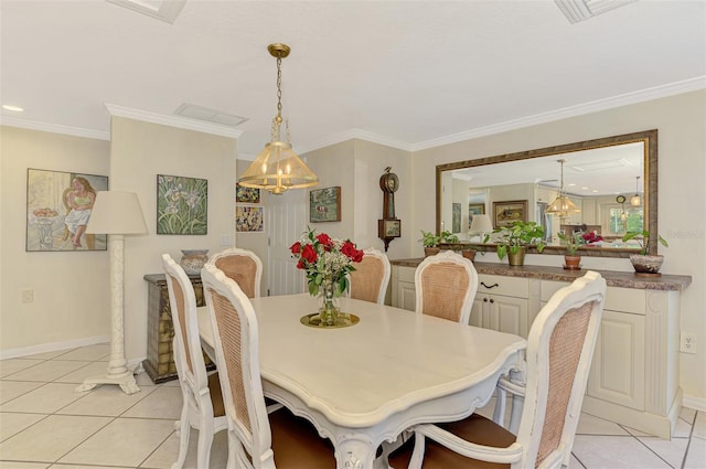403 Picasso Dr, Nokomis, FL 34275 - dining space featuring light tile patterned floors, crown molding, baseboards, and visible vents