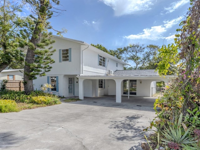 200 Sierra St S, Nokomis, FL 34275 - view of front facade featuring driveway, a carport, fence, and stucco siding