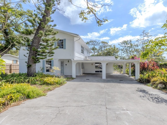 200 Sierra St S, Nokomis, FL 34275 - view of front of home with an attached carport, concrete driveway, stucco siding, and fence