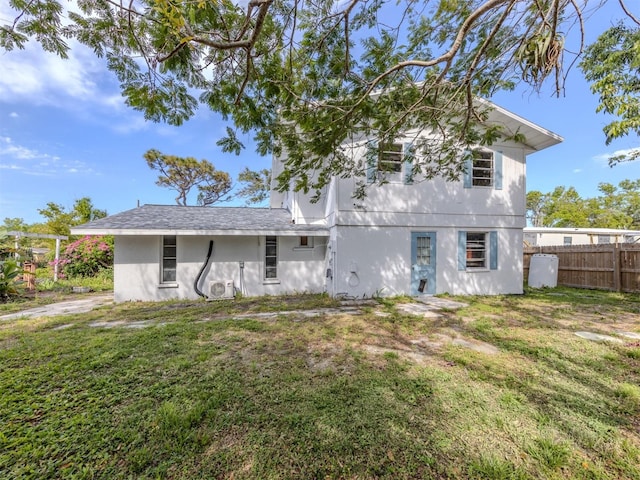 200 Sierra St S, Nokomis, FL 34275 - rear view of property with stucco siding, fence, and a yard