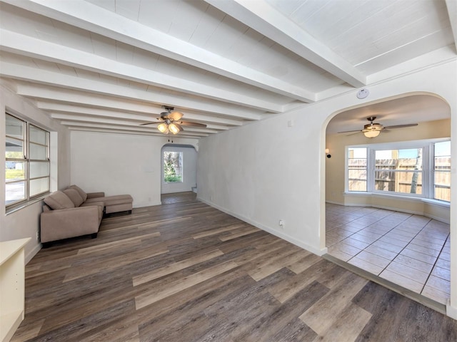 200 Sierra St S, Nokomis, FL 34275 - unfurnished living room with wood finished floors, arched walkways, and a ceiling fan