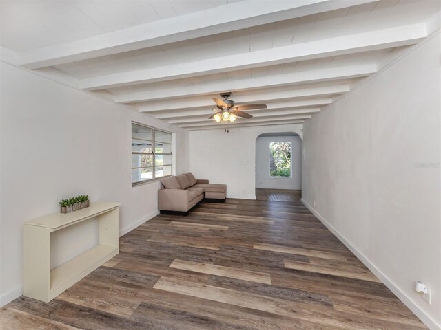 200 Sierra St S, Nokomis, FL 34275 - unfurnished room with a wealth of natural light, beamed ceiling, wood finished floors, and arched walkways